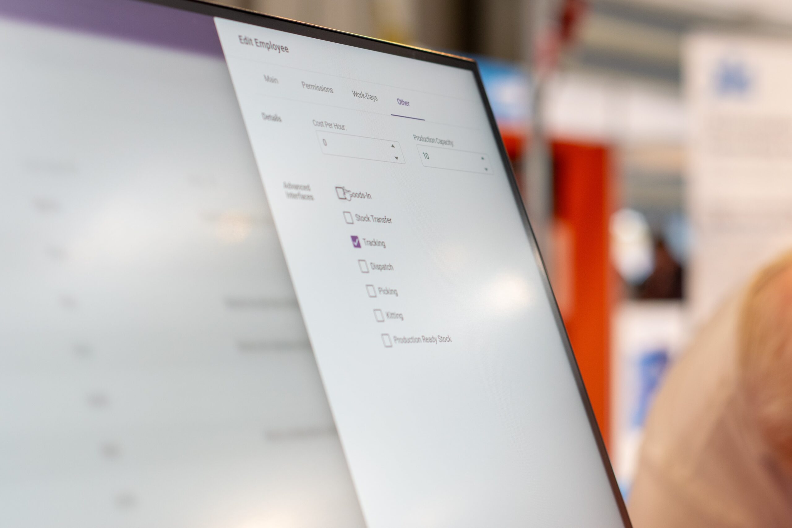 A close-up of DynamxMFG showing the "Edit Employee" interface with "Other" tab selected, showing fields for cost, capacity, and various interface checkboxes.