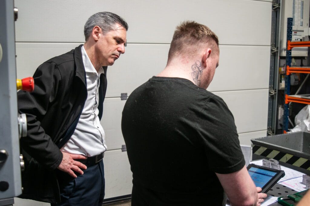A manufacturing consultant reviewing live production data in DynamxMFG